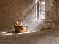 chaise jaune près d'une fenêtre dans un bâtiment abandonné