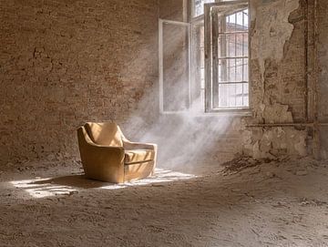 yellow chair by a window in an abandoned building by John Noppen
