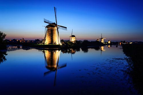 Windmills illuminated at dusk at Blue Hour by iPics Photography