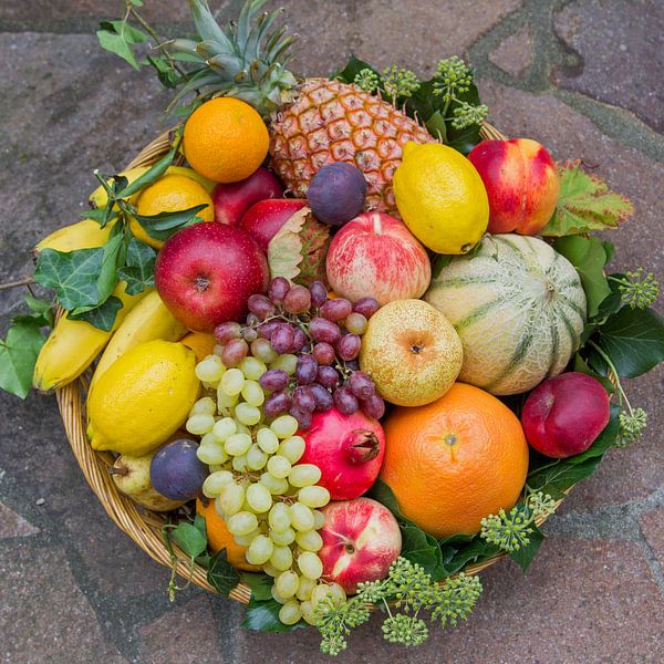 mixed fruits in a rattan basket, with ivy leaves by SusaZoom