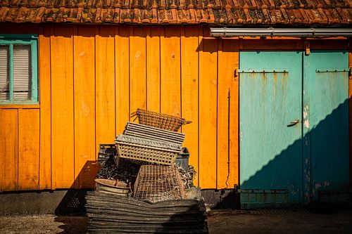 Colorful fisherman's cottage with oyster trays in front of it