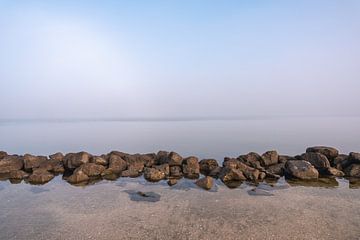 Background with water, rocks and foggy weather