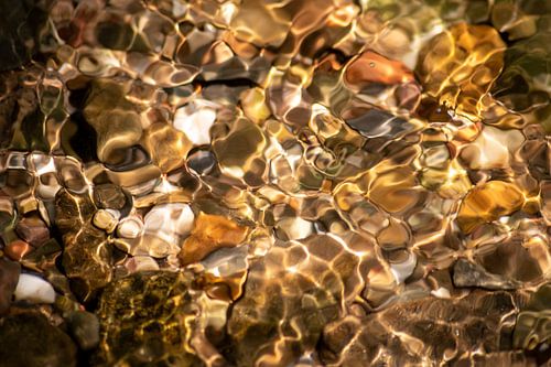 Silky waves in crystal-clear golden spring water