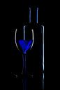 Abstract photo with a glass and a wine bottle on black background by Jolanda Aalbers thumbnail