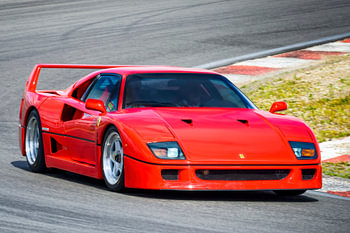 Ferrari F40 driving through a corner at a race track