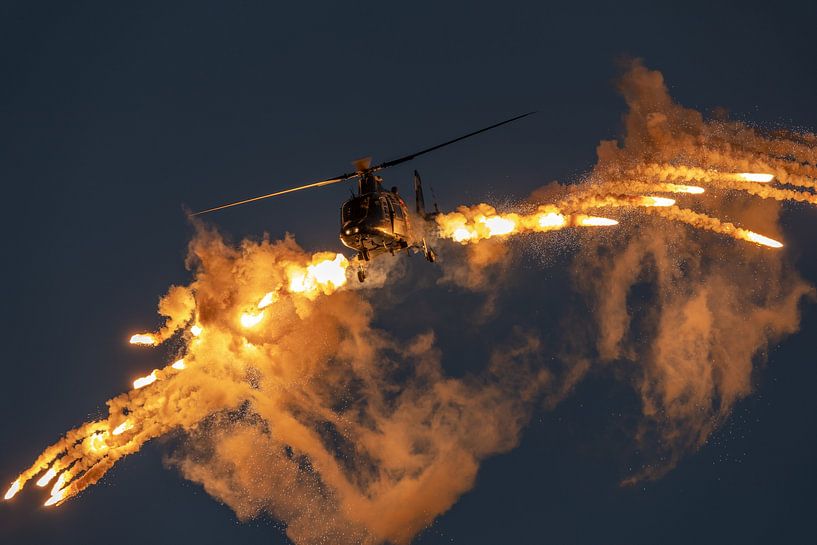 Spectacular fireworks! Agusta A 109 helicopter of the Belgian Air Force fires flares during the Sani by Jaap van den Berg