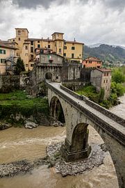 Castelnuovo di Garfagnana in Tuscany in Italy during bad weather and dark clouds by Joost Adriaanse