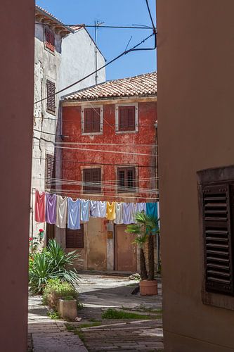 Street in Istria with a colourful washing line.