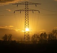 Silhouette of an electricity mast at sunset