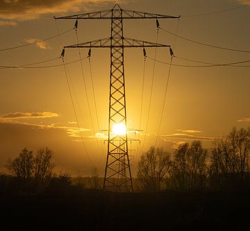 Silhouette of an electricity mast at sunset by Rob Baken