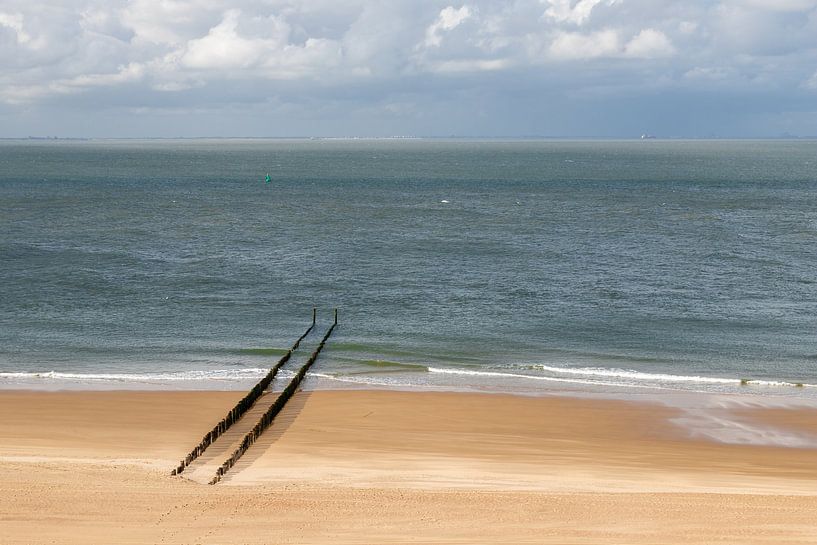 A deserted beach at Zoutelande with a row of breakwaters by Kim Willems