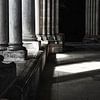 Sun and shade between the columns of an old, French church by Birgitte Bergman