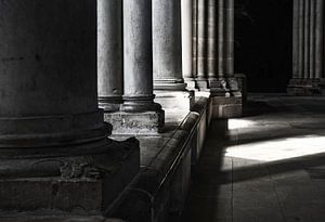 Sun and shade between the columns of an old, French church