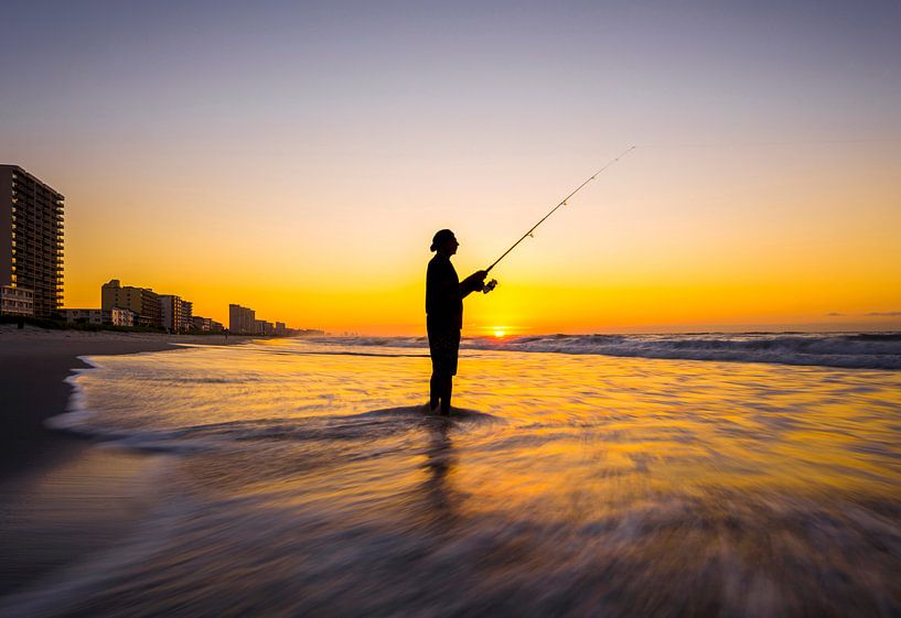 SA11327345 Man with rod on the beach in the evening sun by BeeldigBeeld Food & Lifestyle