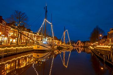 Decorated traditional sailboats in the harbour of Dokkum in the evening by Eye on You