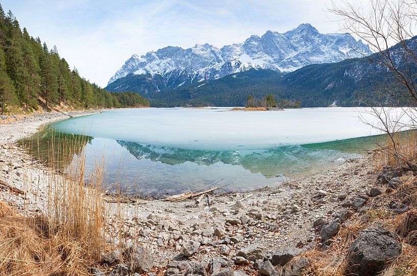 lake Eibsee with icy cover and reflecting mountain. by SusaZoom
