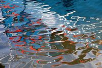 Reflection of a red and white coloured yacht in Urker harbour