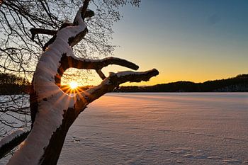 Sunset over frozen lake