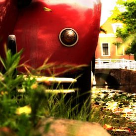 Red Citroen 2cv along a canal in Delft by Jan-Loek Siskens