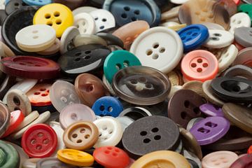 Collection of different sizes and colours of plastic buttons by Frans Rombout