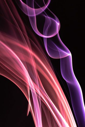 Red and purple incense on a black background