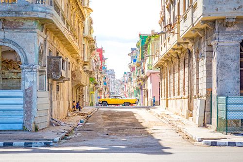 Oldtimer driving through a colorful side street in Havana Cuba by Michiel Ton