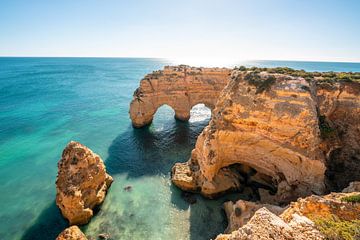 Natural stone arches near Praia da Marinha beach by Leo Schindzielorz