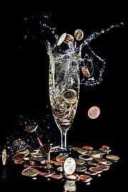 Money coins fall into a champagne glass against a black background by Hans-Jürgen Janda