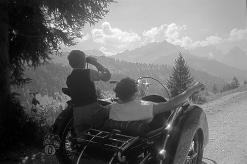 Classic, vintage BMW Motorcycle with sidecar in the Alps 1950s